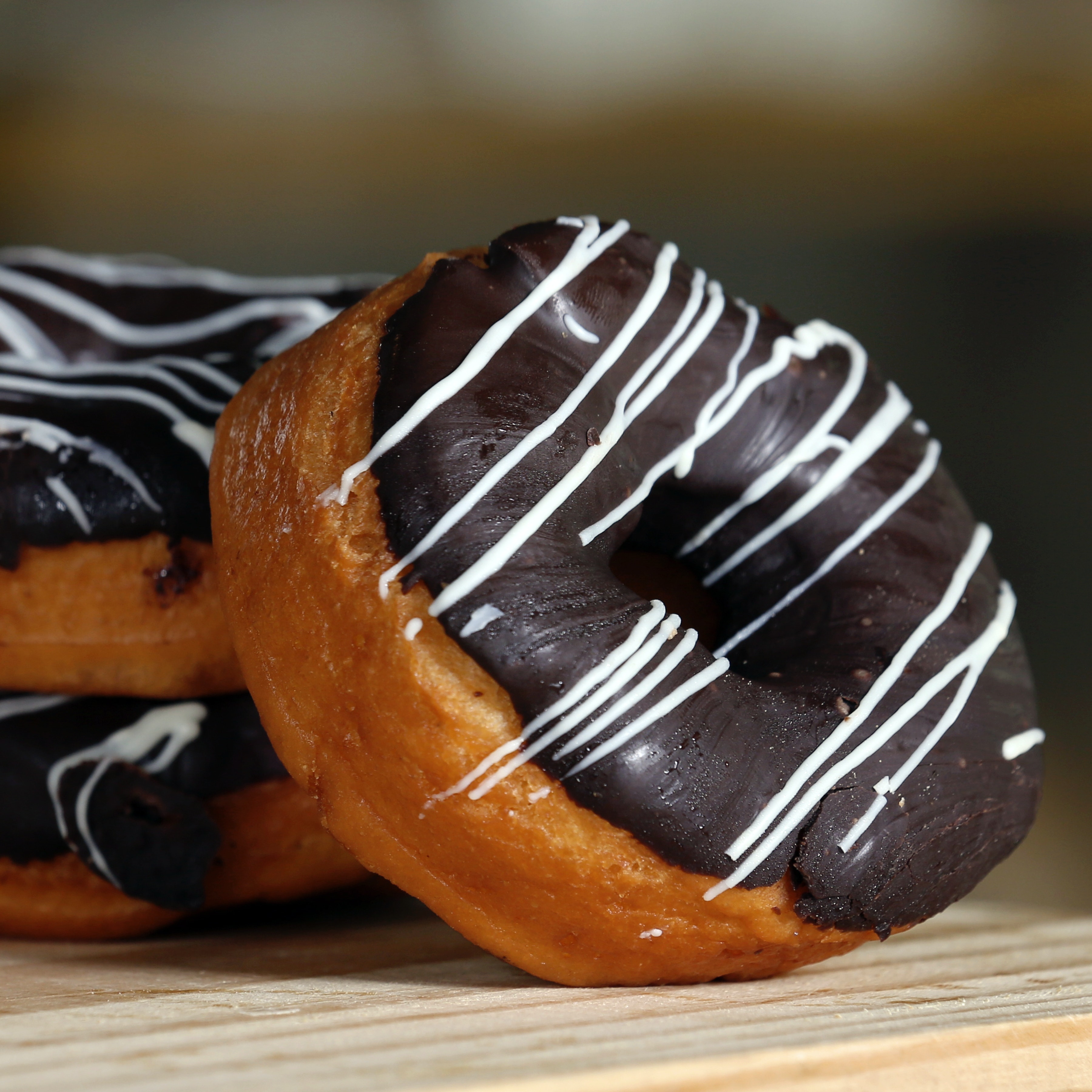 chocolate donut with white glaze stripes